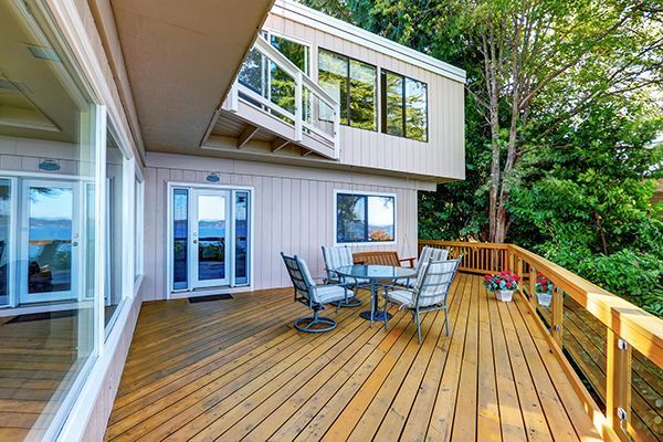 Custom deck installed with railing at a residential home.