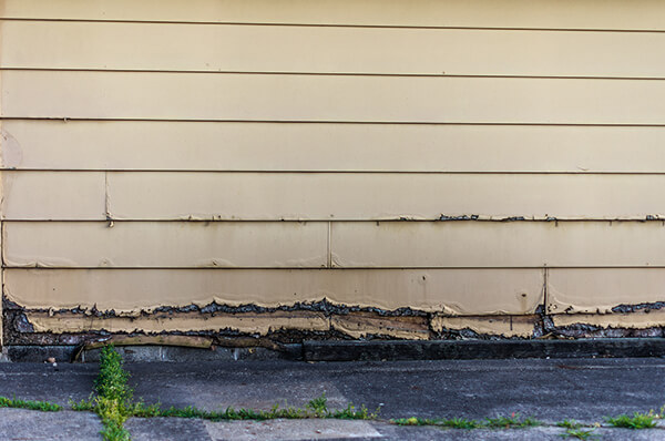 Rotten wood sifing on a residential home in need of repair.